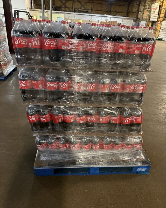 A rebuilt pallet of bottled drinks wrapped and standing square