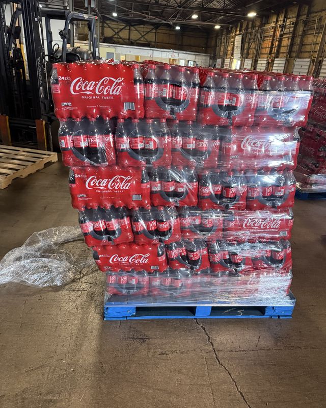 Inside the Plainfield facility, a wrapped pallet staged with a forklift behind it